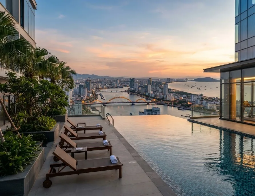 Condo rooftop infinity pool with loungers overlooking the river bridges and bay at sunset