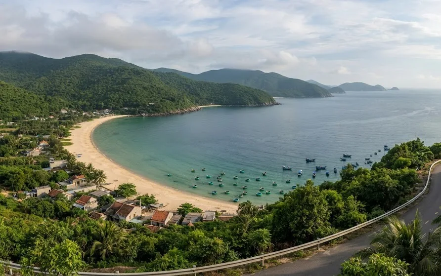 View from a mountain road over a crescent bay with a fishing hamlet and basket boats offshore