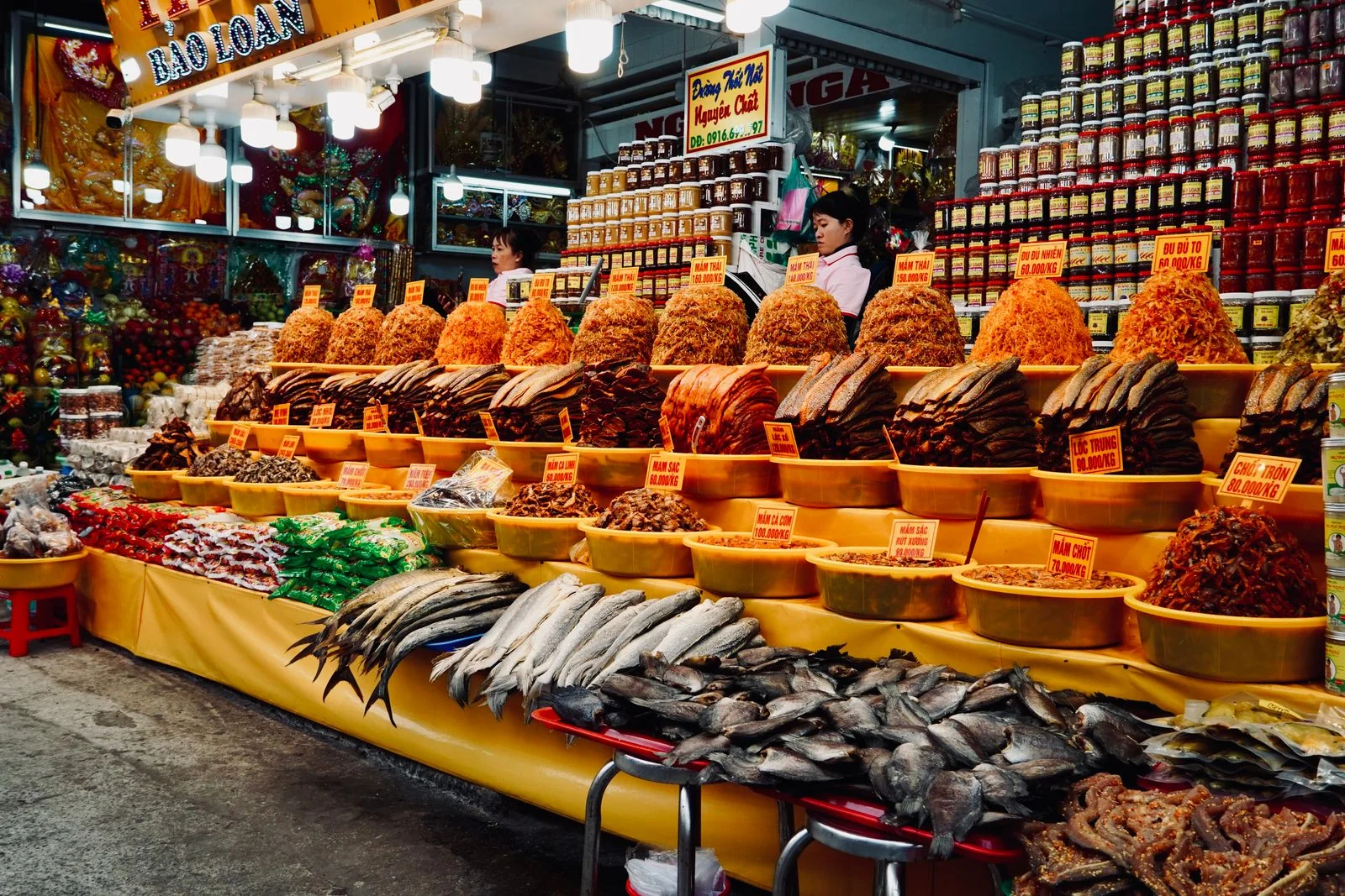 Dried seafood, fish and snacks piled high on a Vietnamese market stall