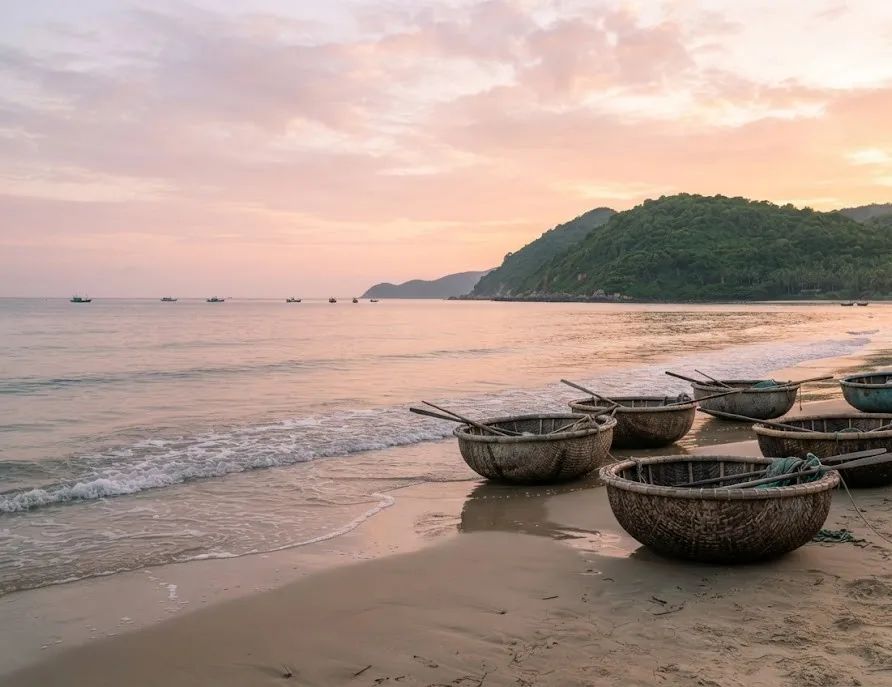 Round basket boats on a quiet beach at sunrise in central Vietnam
