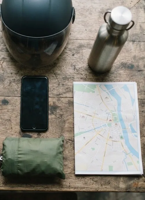 Getting-around kit: helmet, phone, water bottle, rain poncho and a city map